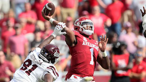 Oct 21, 2023; Fayetteville, Arkansas, USA; Mississippi State Bulldogs defensive end Deonte Anderson (91) hits the arm of Arkansas Razorbacks quarterback KJ Jefferson (1) during the second half by at Donald W. Reynolds Razorback Stadium. Mississippi State won 7-3. Mandatory Credit: Nelson Chenault-USA TODAY Sports